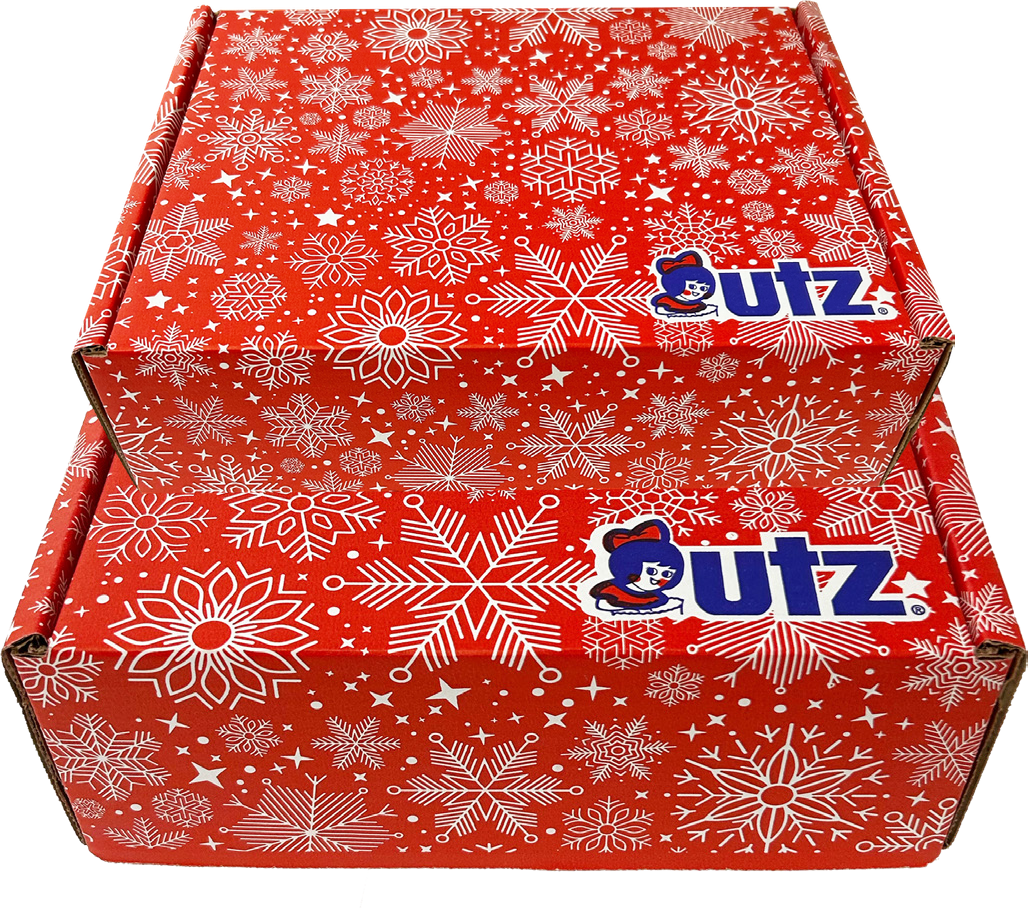Small and large red Utz gift boxes with a white snowflake pattern, stacked